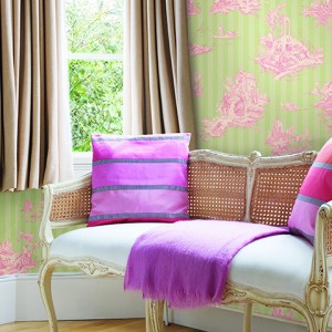 Pink cushions on wicker sofa  London  UK
